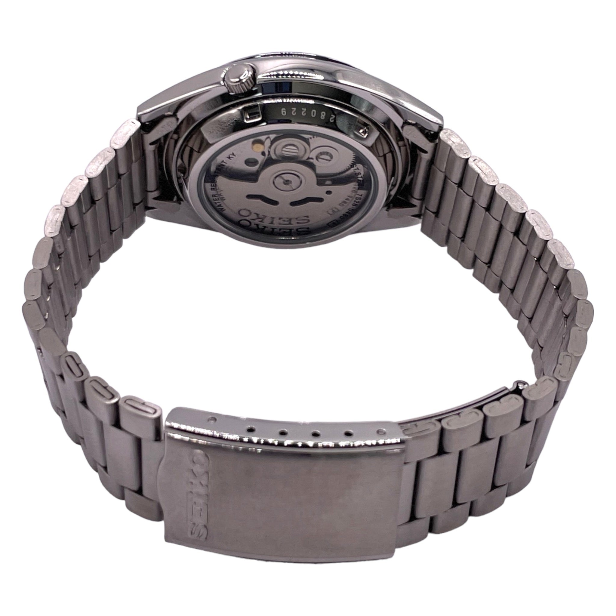 Montre Seiko avec bracelet métallique et cadran de 37mm, fond argenté, index et aiguilles dorées, vue de dos